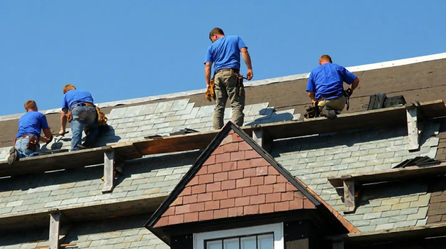 Roof replacement in progress with a team of professional contractors installing new shingles on a residential home in Tempe, AZ